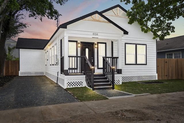 view of front of home featuring fence