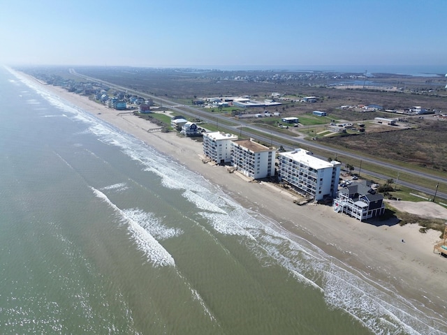 aerial view with a water view and a view of the beach