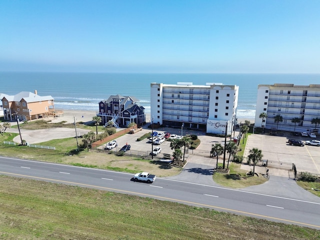 birds eye view of property featuring a beach view and a water view