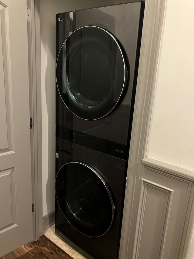 clothes washing area with laundry area and stacked washer and clothes dryer