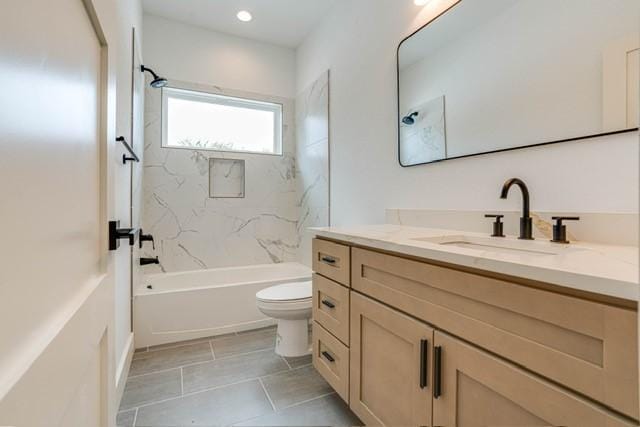 full bath with tile patterned floors, washtub / shower combination, vanity, and toilet