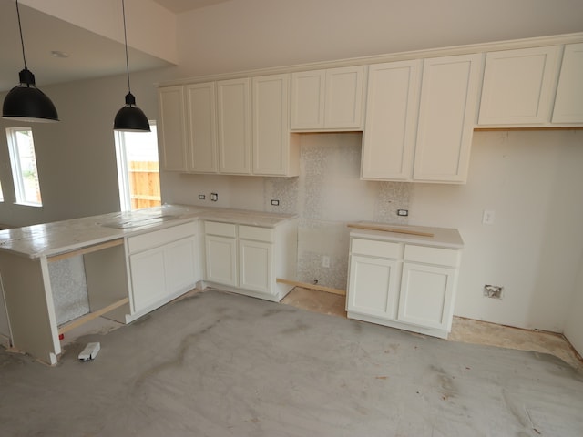 9738 Fuller Frk, Montgomery, TX 77316 - kitchen with a peninsula, decorative light fixtures, and white cabinetry
