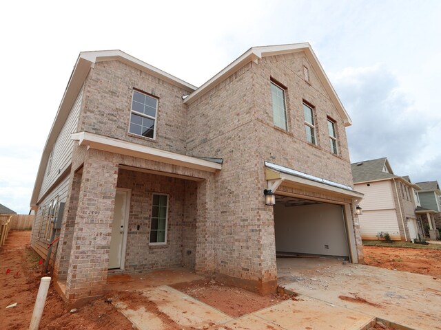 9738 Fuller Frk, Montgomery, TX 77316 - rear view of property with an attached garage, concrete driveway, and brick siding