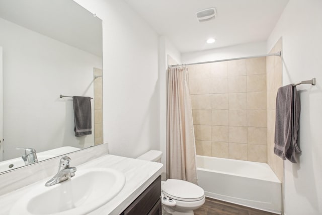 full bath with toilet, wood finished floors, vanity, visible vents, and shower / bath combo