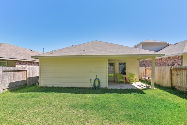 rear view of property with a patio area, a fenced backyard, and a lawn