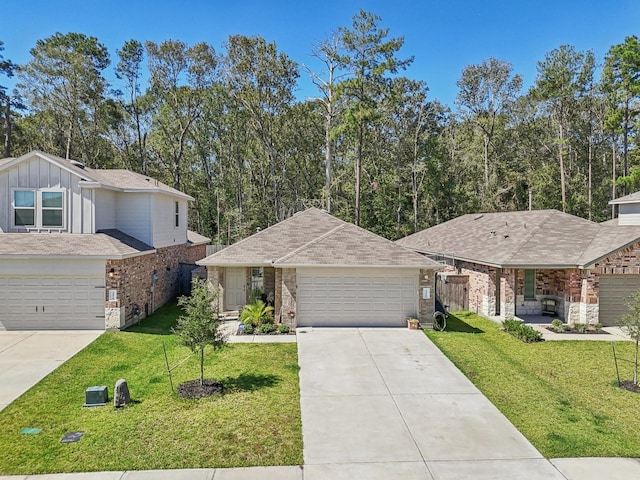 view of front of property featuring an attached garage, brick siding, concrete driveway, board and batten siding, and a front yard