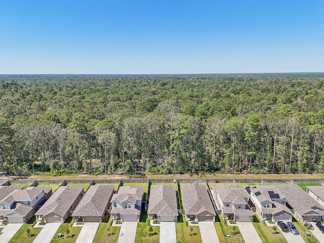 birds eye view of property with a residential view and a wooded view