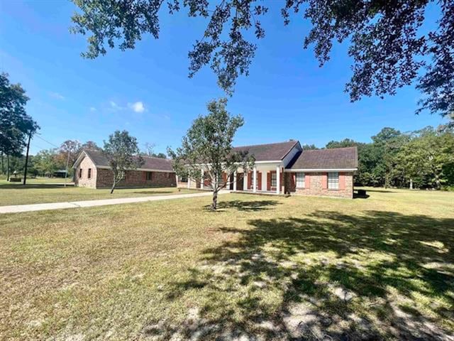 ranch-style home with a front lawn