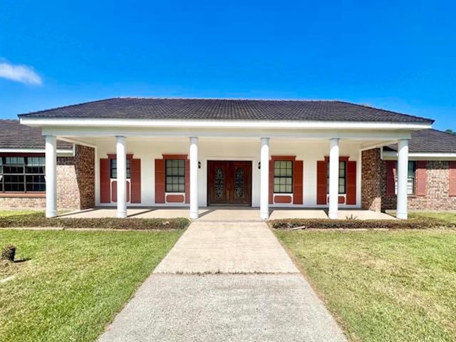 view of front of home with a front lawn and a porch