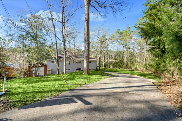 653 Terrace Trl, Goodrich, TX 77335 - view of front of property with a front lawn and driveway