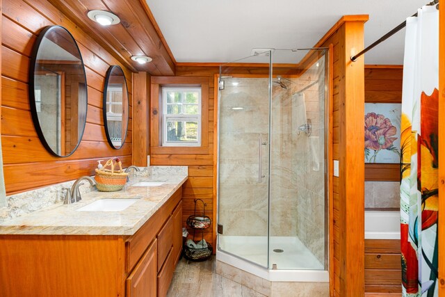 653 Terrace Trl, Goodrich, TX 77335 - bathroom with a shower stall, double vanity, and wood finished floors