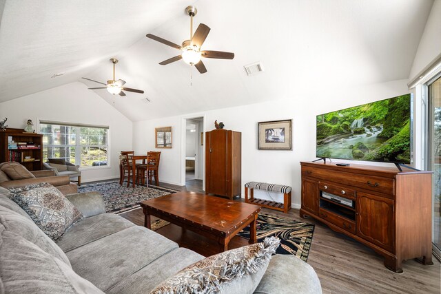 653 Terrace Trl, Goodrich, TX 77335 - living room with wood finished floors, a ceiling fan, plenty of natural light, and high vaulted ceiling