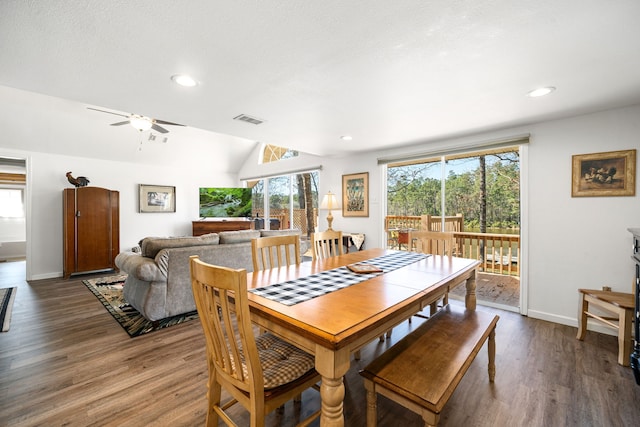 dining area featuring lofted ceiling, baseboards, visible vents, and wood finished floors