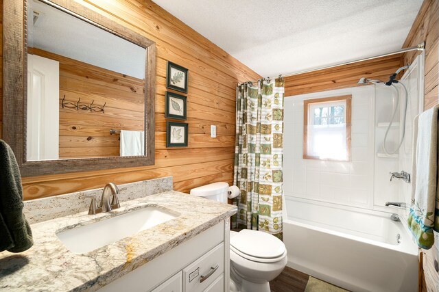 653 Terrace Trl, Goodrich, TX 77335 - full bath featuring vanity, wooden walls, shower / tub combo, and a textured ceiling