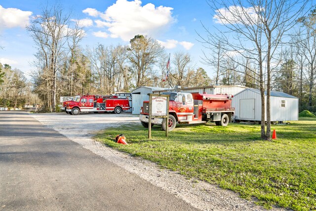 653 Terrace Trl, Goodrich, TX 77335 - view of front of property with a front lawn and a shed