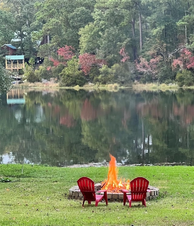 653 Terrace Trl, Goodrich, TX 77335 - view of green lawn featuring a fire pit, a water view, and a view of trees