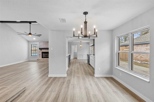25511 Long Hill Ln, Spring, TX 77373 - unfurnished dining area with light wood-style floors, plenty of natural light, visible vents, and ceiling fan with notable chandelier