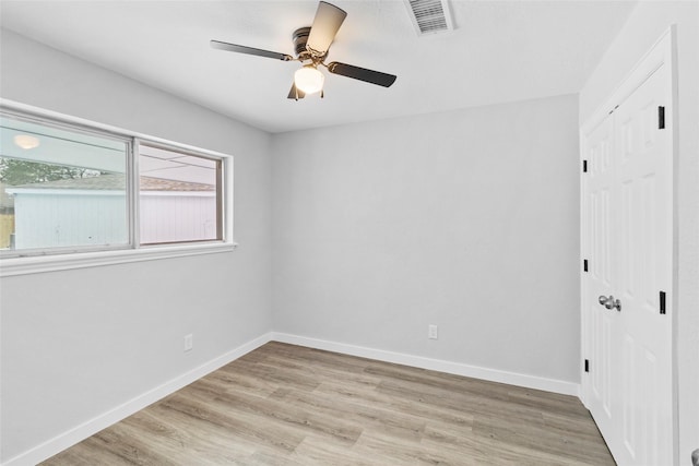 unfurnished bedroom with a ceiling fan, visible vents, baseboards, a closet, and light wood finished floors