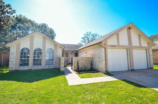 single story home with an attached garage, a front yard, concrete driveway, and brick siding