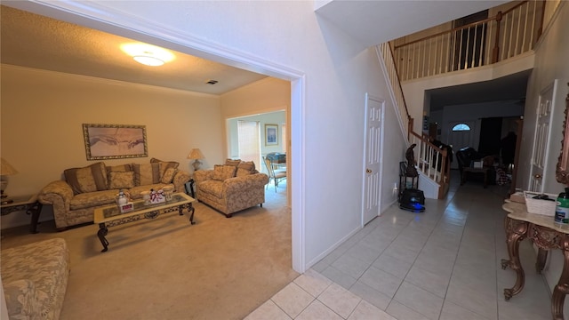 living room featuring light tile patterned floors, visible vents, light colored carpet, stairway, and ornamental molding