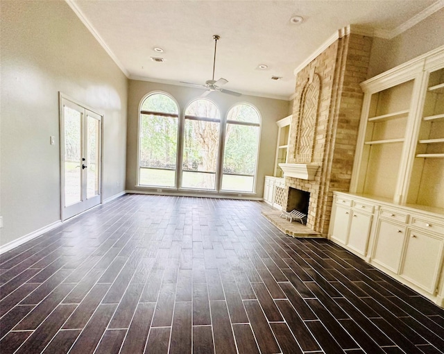 unfurnished living room with baseboards, ceiling fan, ornamental molding, dark wood-style flooring, and a fireplace