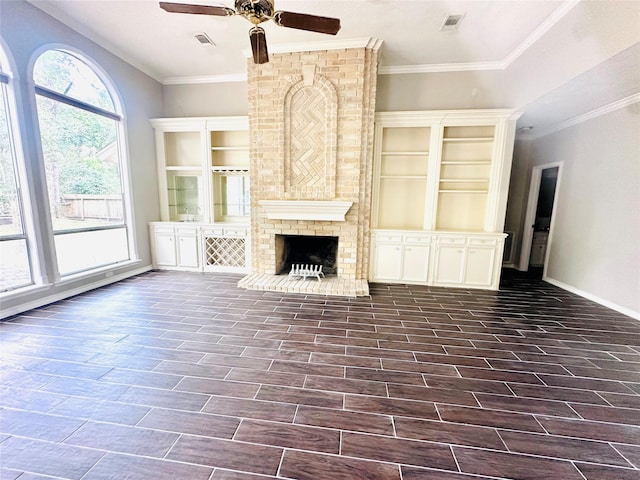 unfurnished living room featuring wood finish floors, a brick fireplace, visible vents, and baseboards