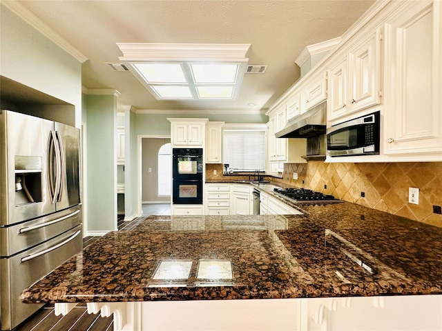 kitchen featuring tasteful backsplash, a peninsula, stainless steel appliances, crown molding, and under cabinet range hood