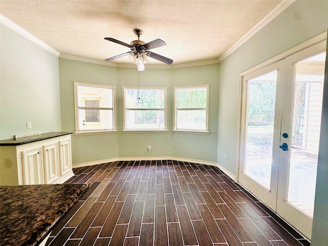 unfurnished sunroom with a ceiling fan and french doors