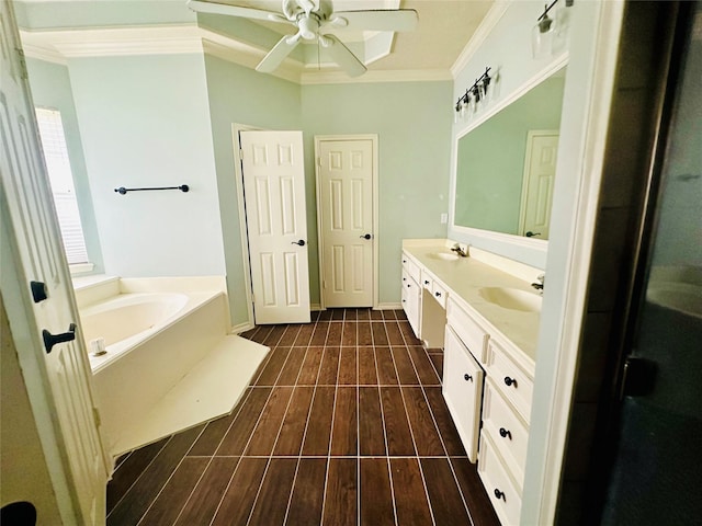 full bathroom featuring a garden tub, crown molding, a sink, and wood finished floors