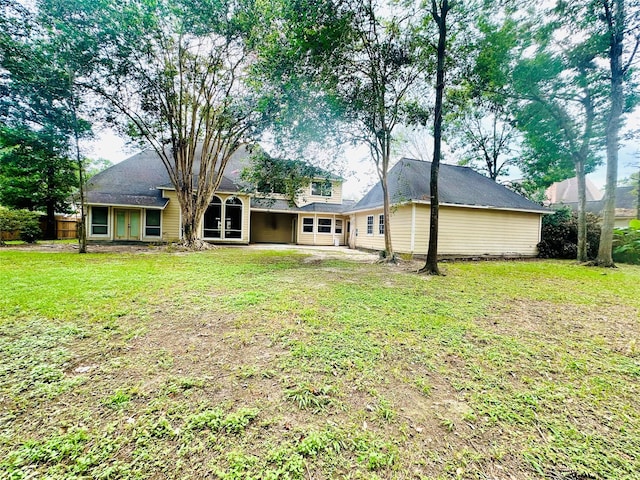 back of house with a lawn