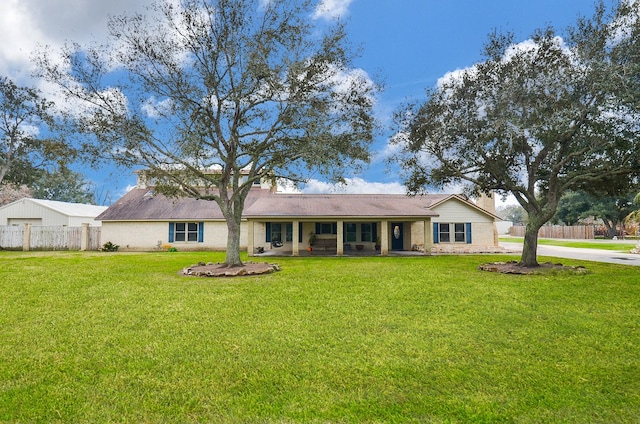 single story home with a front lawn, fence, and brick siding