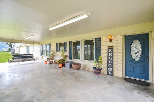 view of exterior entry featuring brick siding