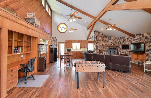 living area featuring a fireplace, built in desk, wood finished floors, high vaulted ceiling, and beamed ceiling