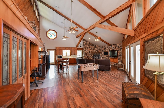 living area with high vaulted ceiling, french doors, beamed ceiling, and wood finished floors