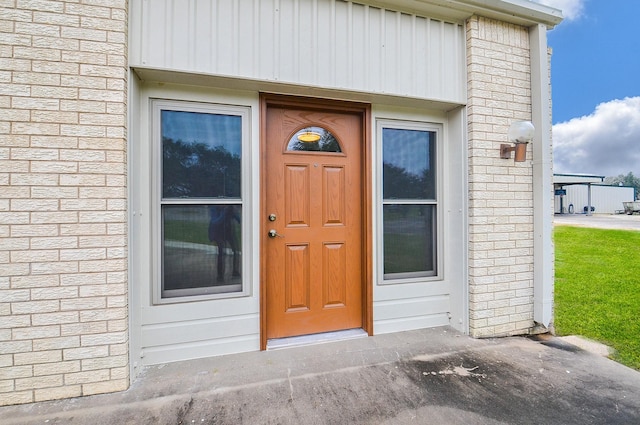 property entrance featuring brick siding