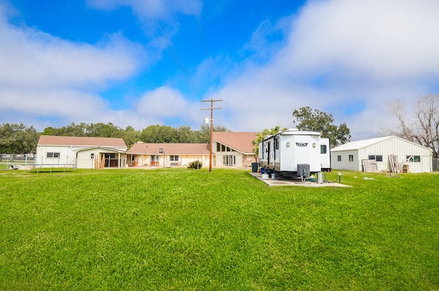 rear view of property with a yard