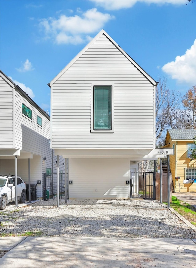 view of side of home with driveway and fence