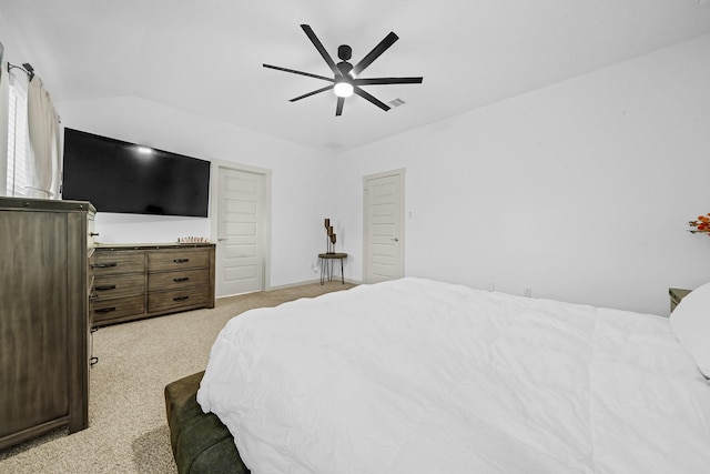 carpeted bedroom with vaulted ceiling, visible vents, and ceiling fan