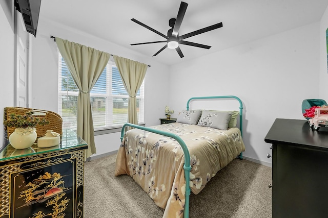 bedroom with ceiling fan, baseboards, and light carpet