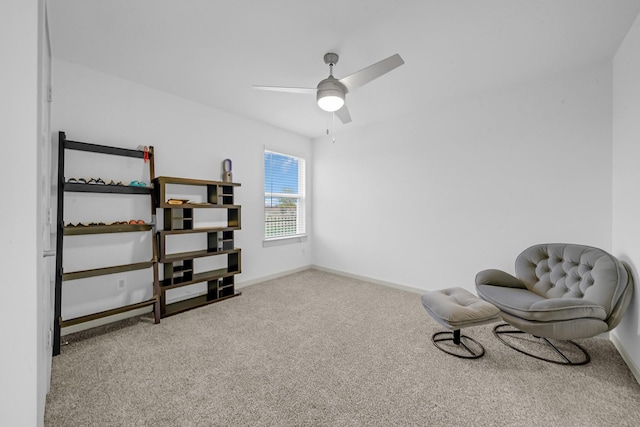 living area featuring baseboards, carpet floors, and ceiling fan