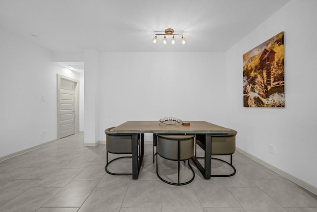 dining room featuring light tile patterned floors and baseboards