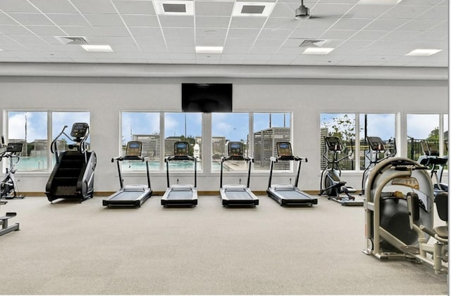 gym featuring carpet flooring, visible vents, and a towering ceiling