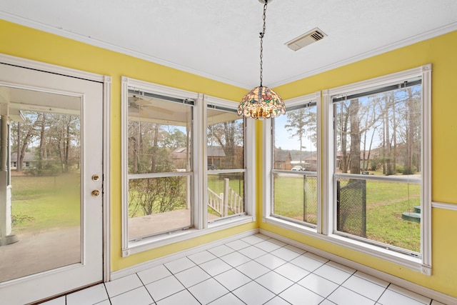 unfurnished dining area featuring visible vents, crown molding, and light tile patterned floors