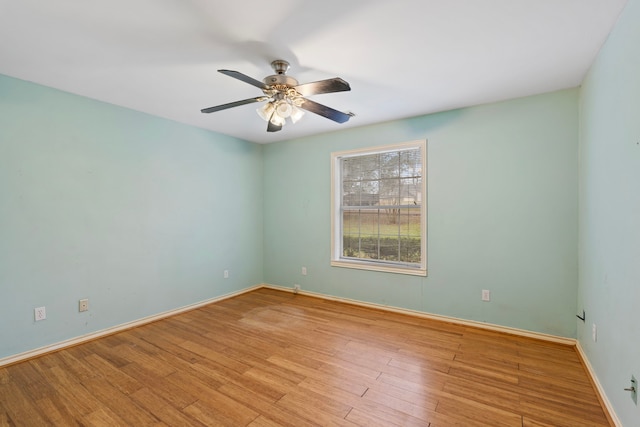 unfurnished room with ceiling fan, light wood-style flooring, and baseboards