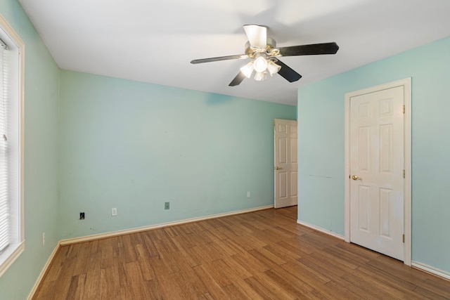 unfurnished bedroom featuring light wood-style floors, ceiling fan, and baseboards