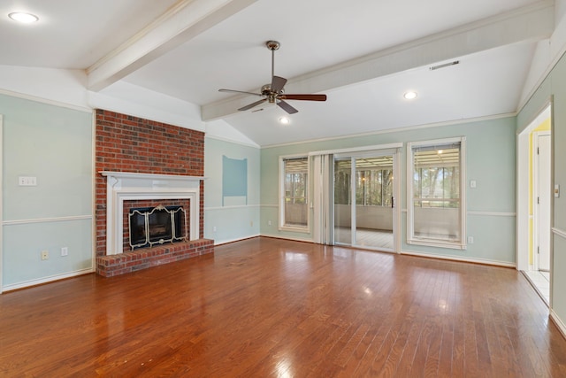 unfurnished living room with lofted ceiling with beams, a fireplace, baseboards, and wood finished floors