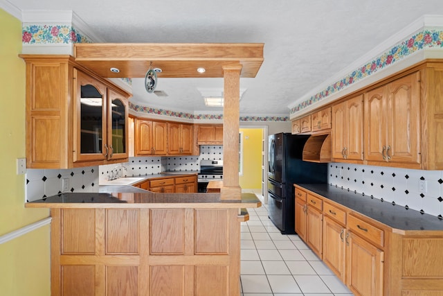 kitchen with a peninsula, a sink, freestanding refrigerator, stainless steel electric range oven, and glass insert cabinets