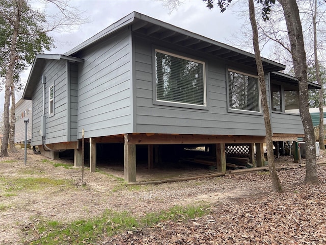 view of side of home with a carport