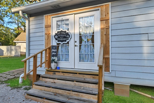 view of exterior entry featuring french doors