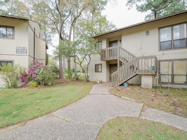 surrounding community featuring a yard and stairway